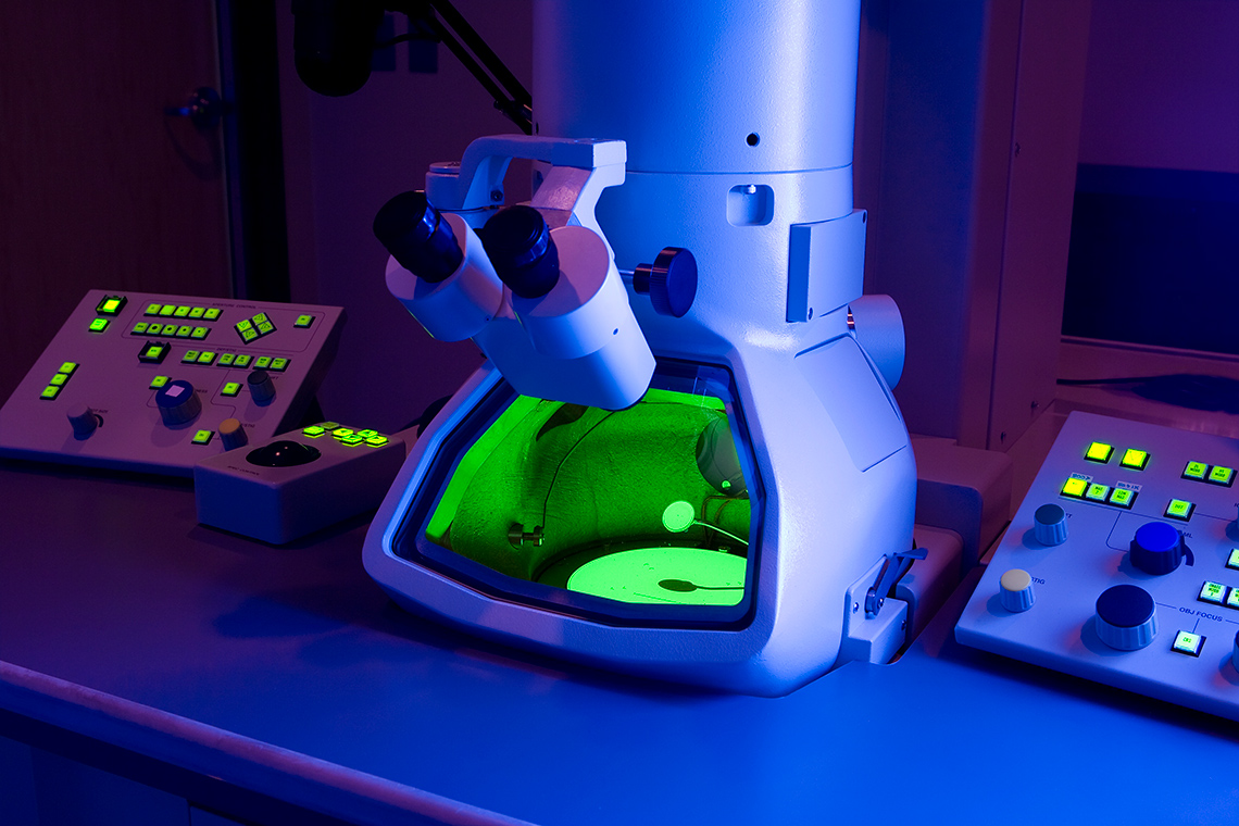 an electron microscope. A large cylinder base with a large window for viewing. Two lenses point into the window to magnify.