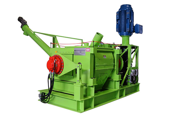 Large green machine with a hopper and several protruding parts.