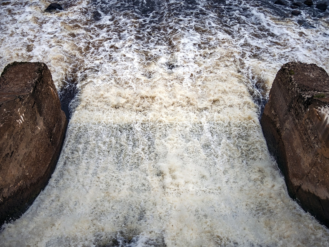 Hydraulic structure on a river. Two stone walls controlling the flow of water.