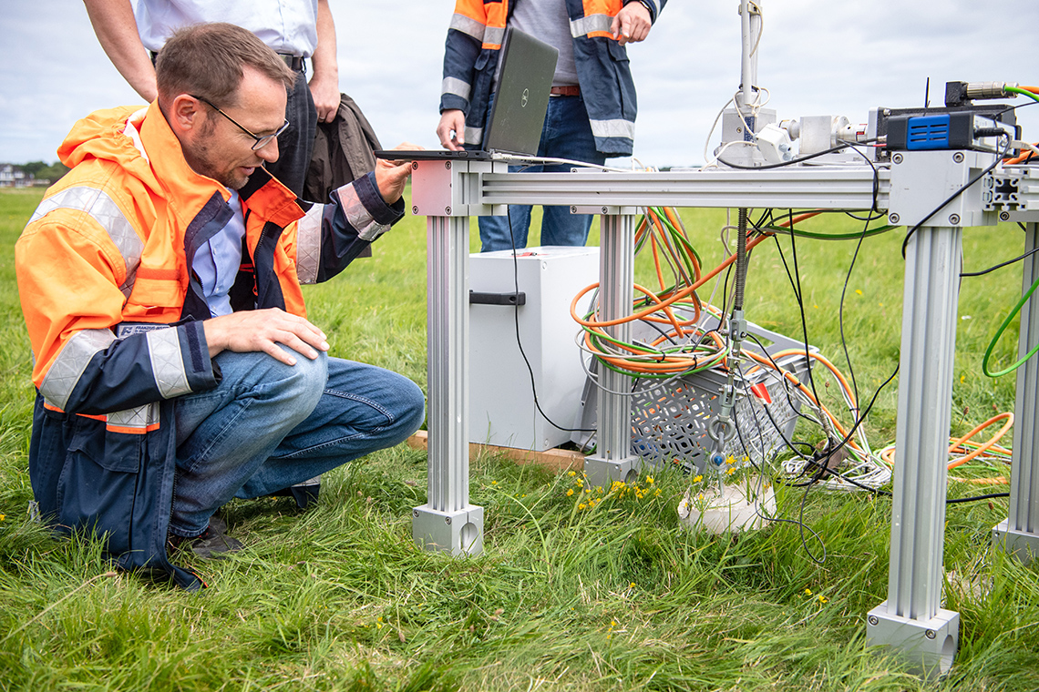 An ecological engineer examining equipment in the field