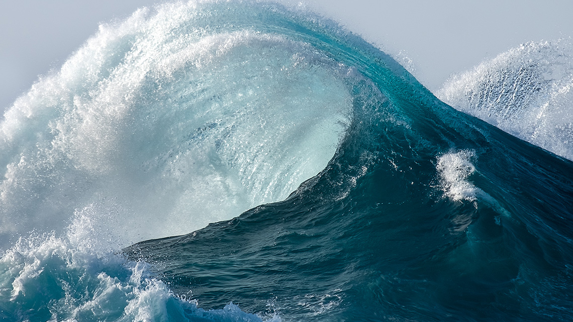 A wave is splashing in the ocean.