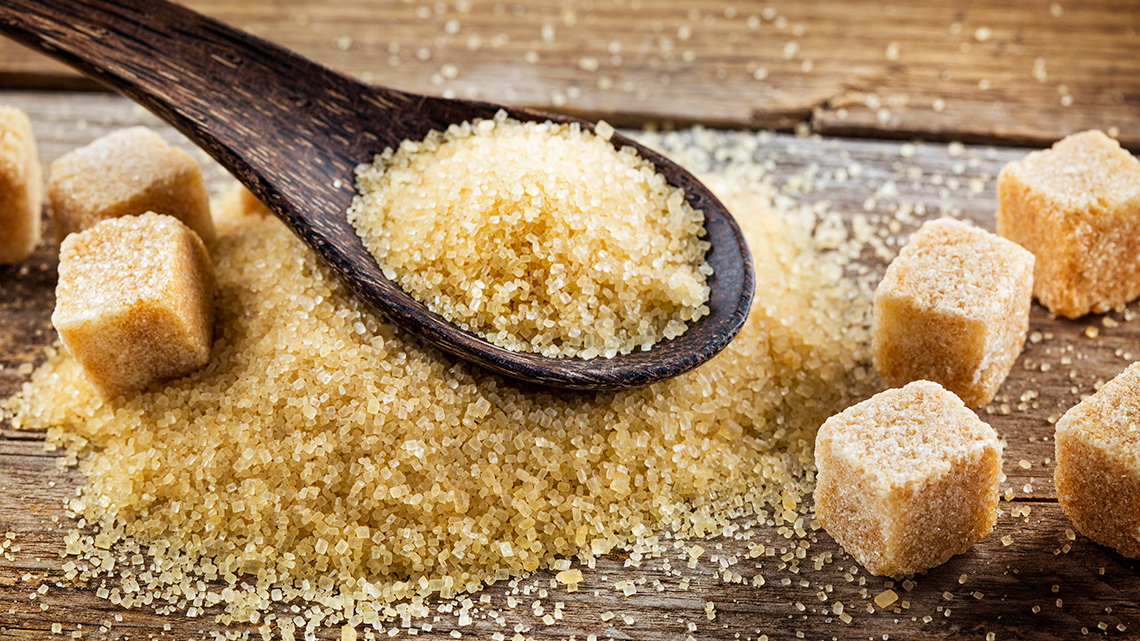 Sugar cubes and sugar on a spoon.