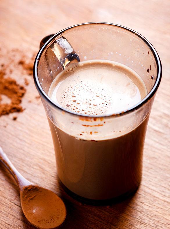 Chocolate powder has been mixed with milk to make chocolate milk.