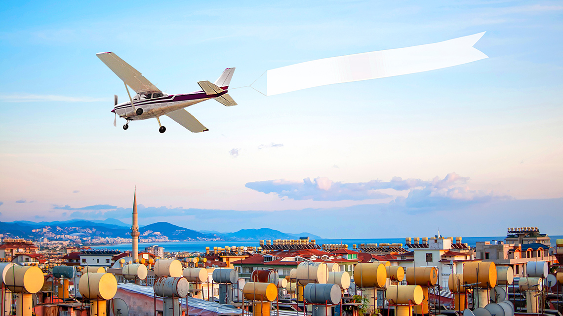 An airplane flying with a banner.