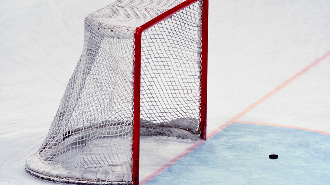 A hockey net on an ice rink.