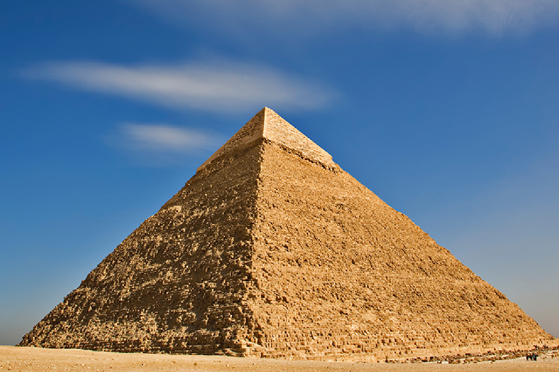 A huge stone pyramid in a desert.