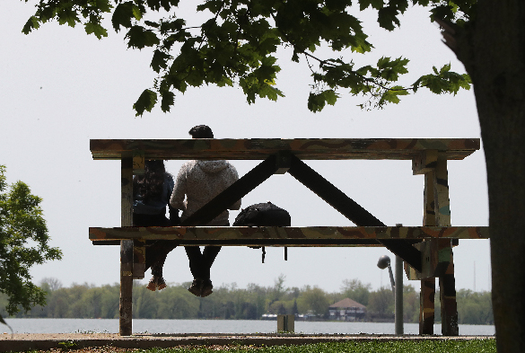 Over-sized Picnic Table Two people sitting on an over-sized picnic table.