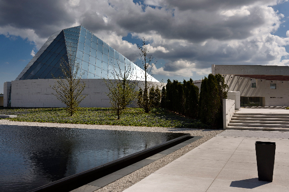 Ismaili Centre in Aga Khan Park A glass building with a pyramid-shaped roof.