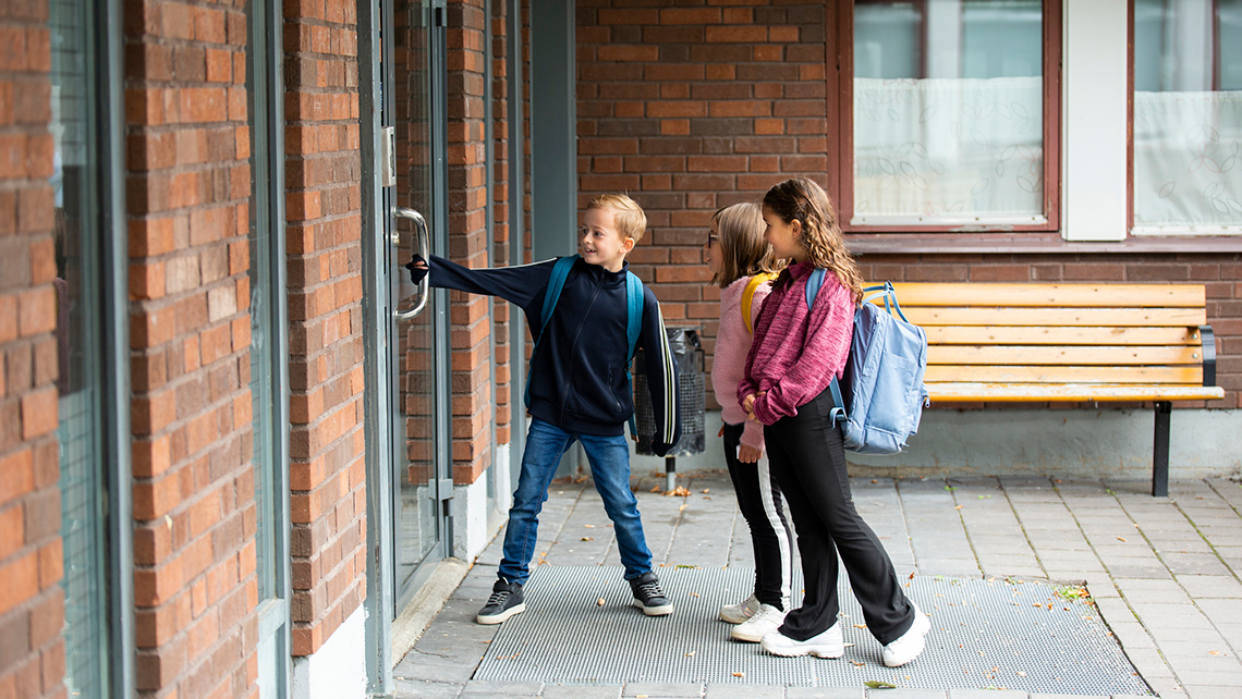 A child pulling open a door.