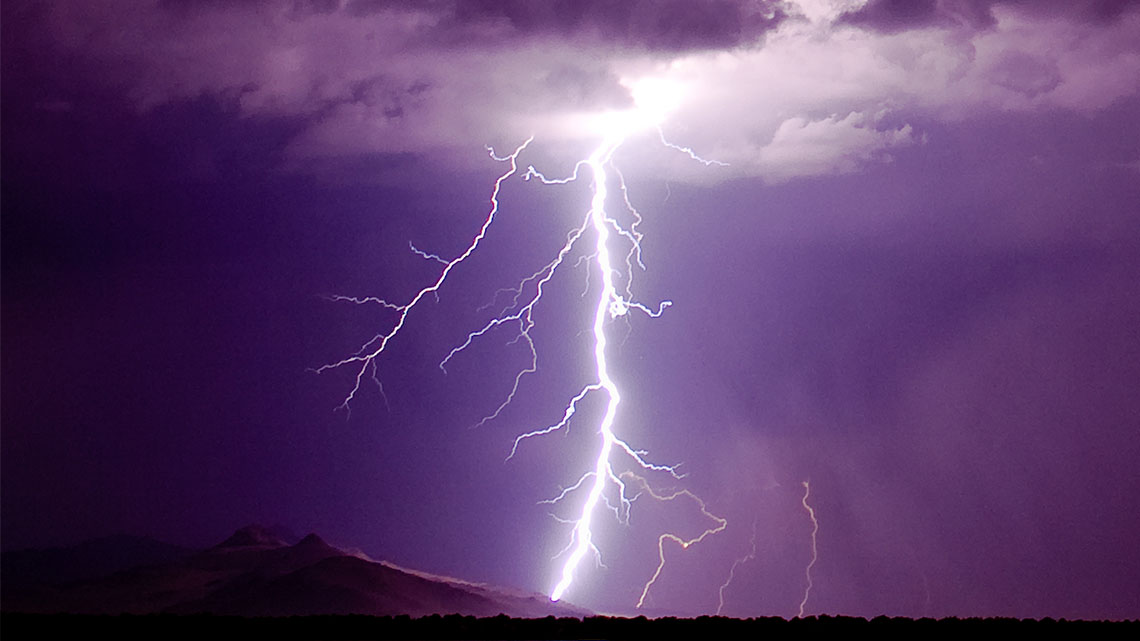 A bolt of lightning flashes in the sky.