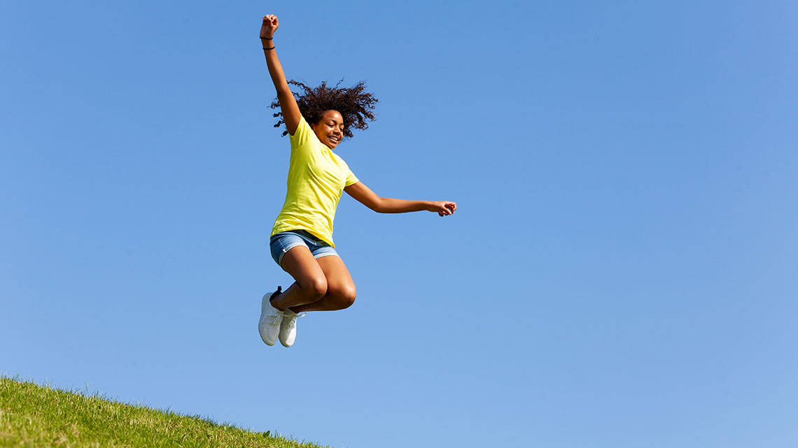 A child jumping up in the air.