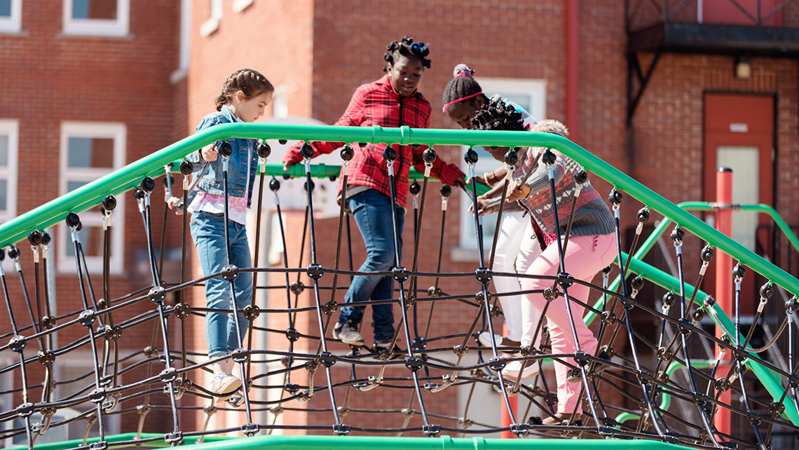 A group of children are playing on a playground equipment.