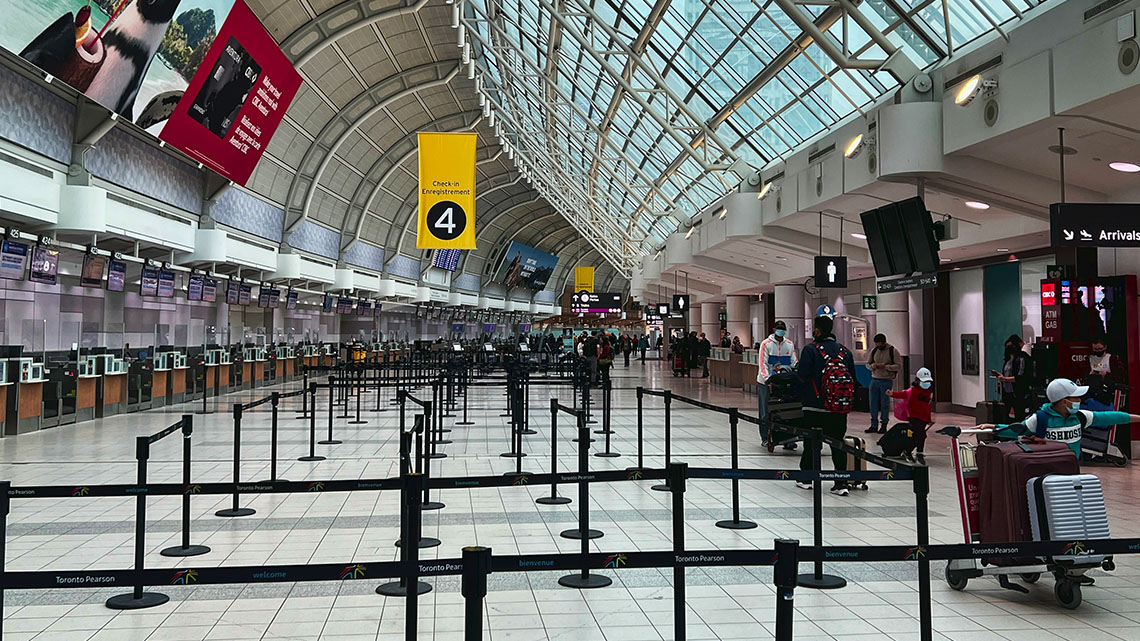 An interior view of Toronto Pearson airport displaying structural support beams