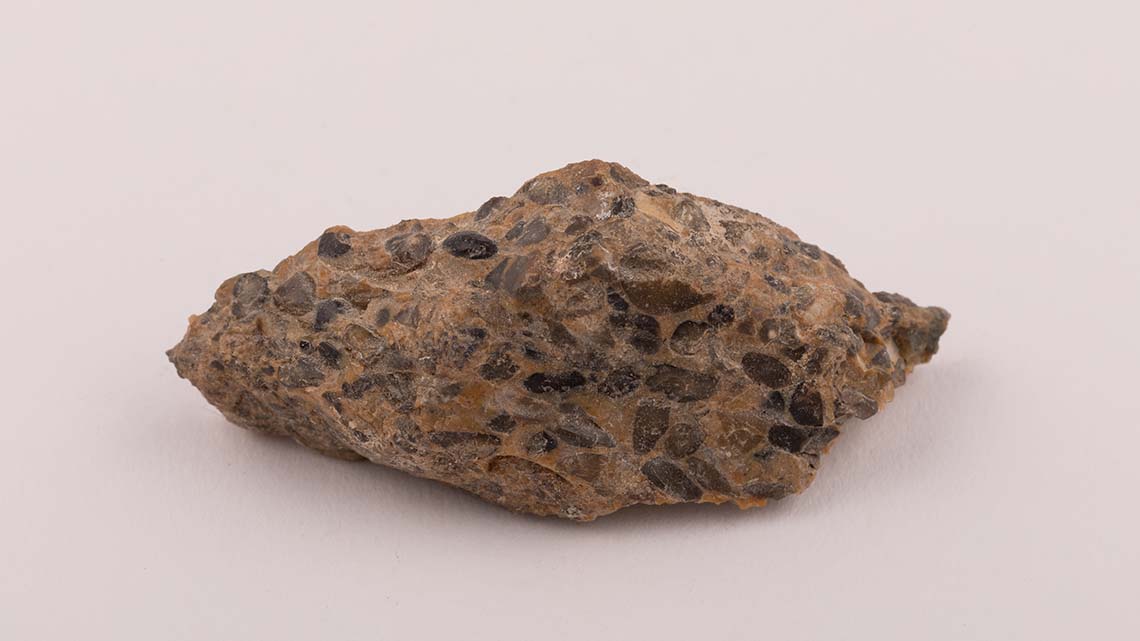 This is a rock made of different minerals, including rounded flint pebbles in a fine quartz mix.
