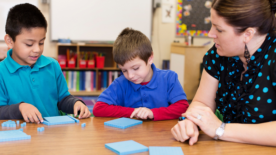 Two kids learning counting by using coloured blocks.