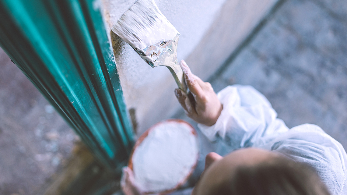 A person painting a wall