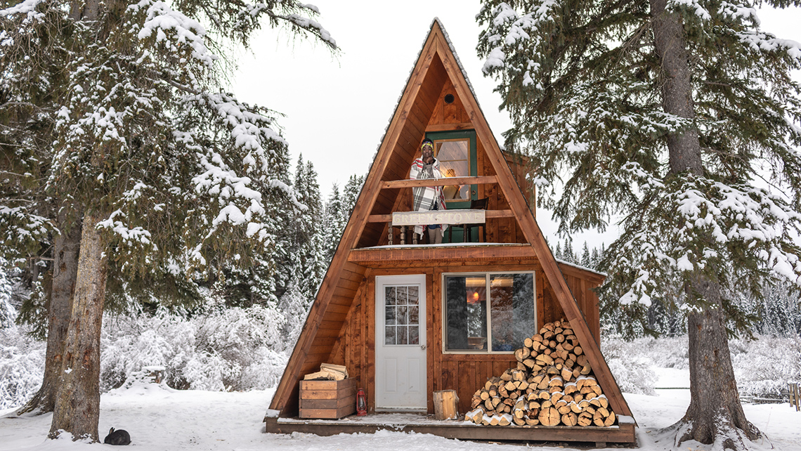 Winter cabin covered in snow during the winter.