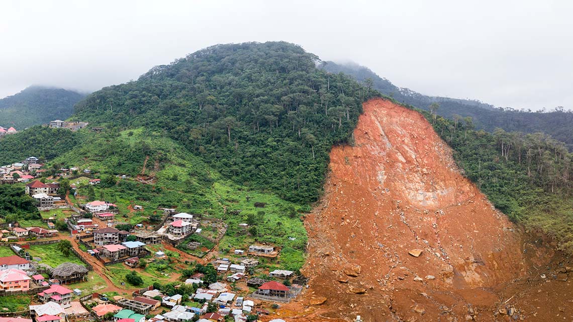 Landslide or mudslide of a mountain near homes and villages.