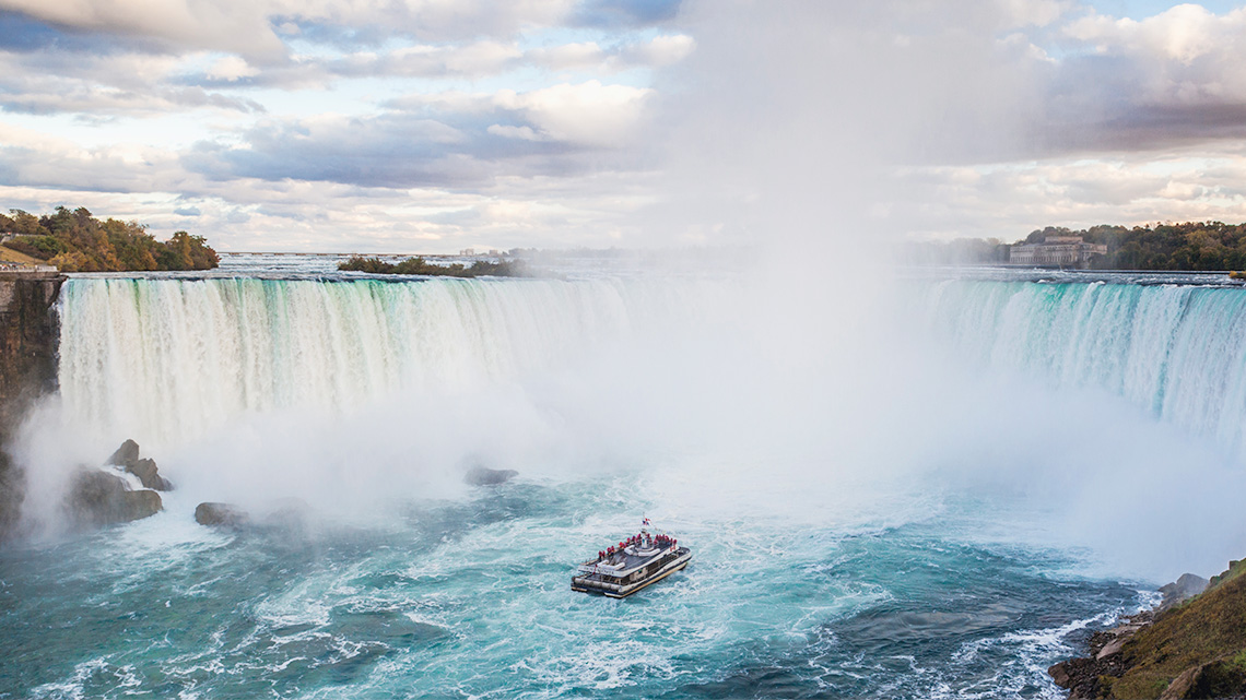 A full view of Niagara Falls with mist in the air