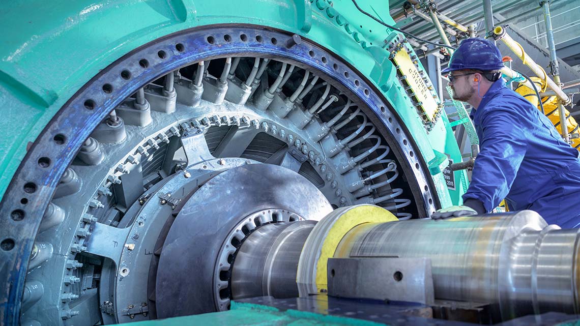 Engineer inspecting a generator in a nuclear power station.