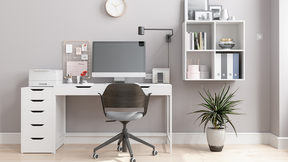 A home office with a light switch on the wall and various items plugged into an electrical outlet.