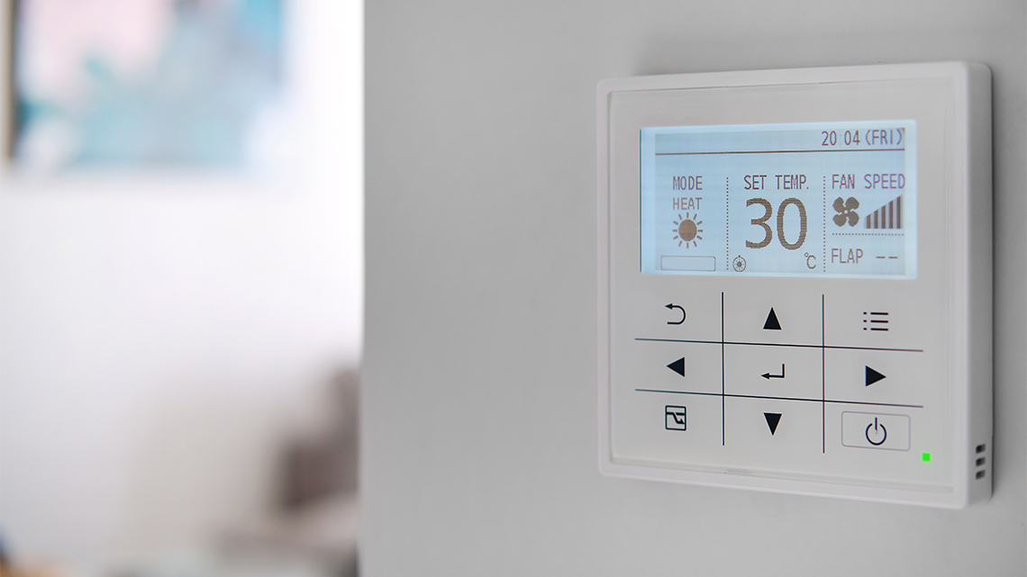 A thermostat displaying the ambient temperature and controls to adjust it.