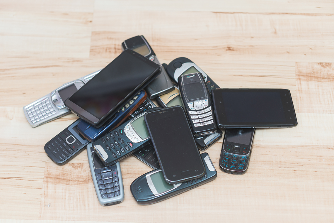 A pile of old and new cell phones.