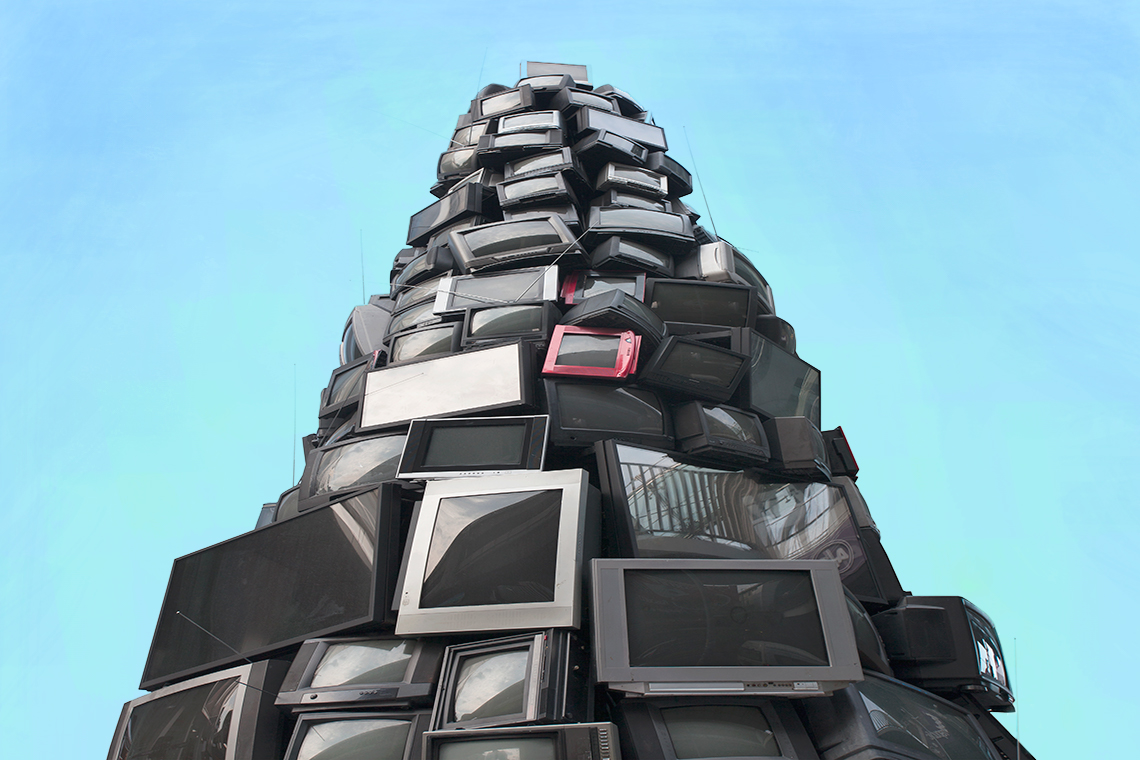 A tall pile of old televisions and electronic screens.