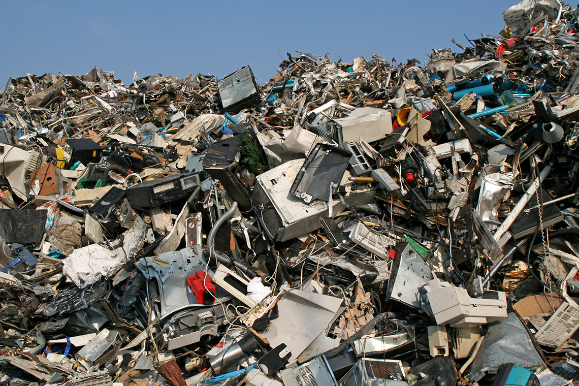 An image of a computer dump site. There is one very large pile of old computers and monitors.