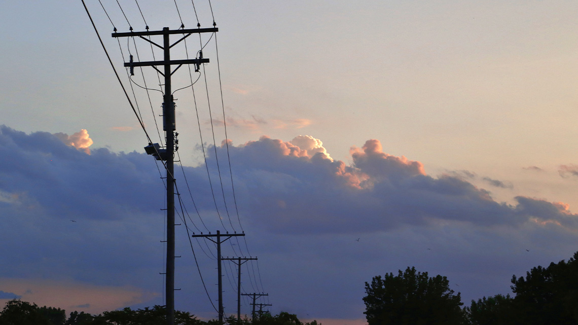 A series of power lines connecting to each other in a neighbourhood 