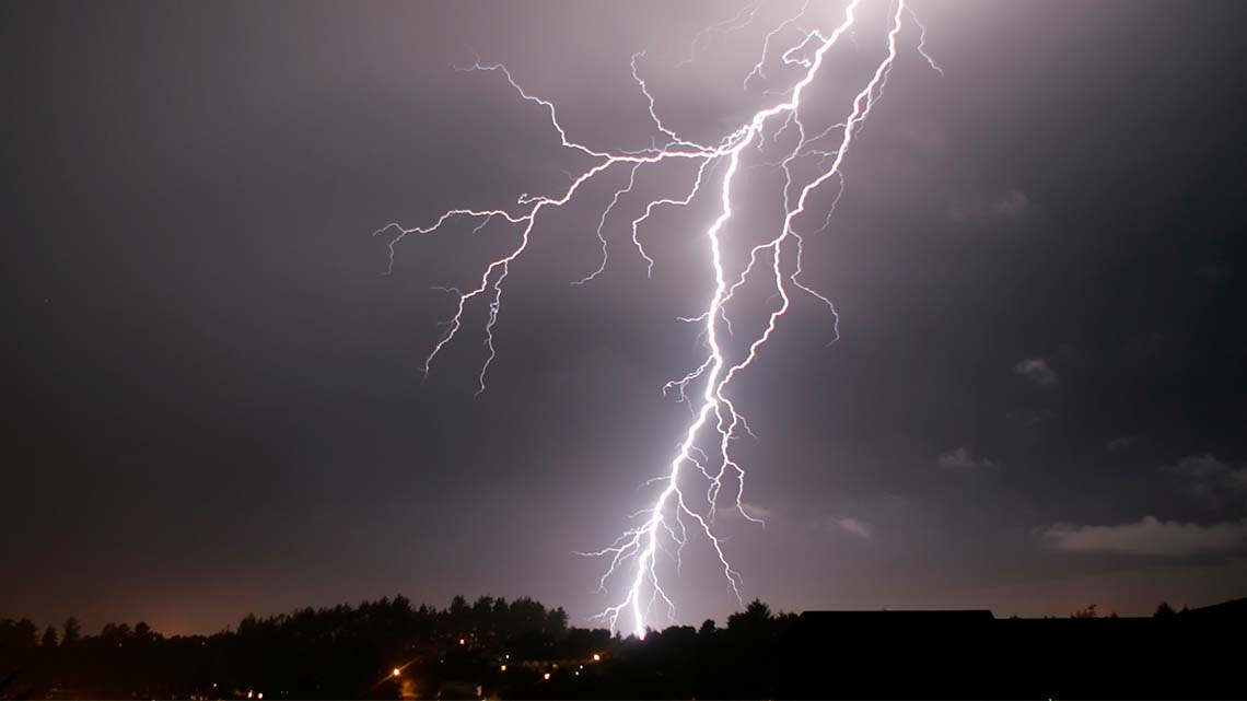 Lightning striking across the sky during a thunderstorm.