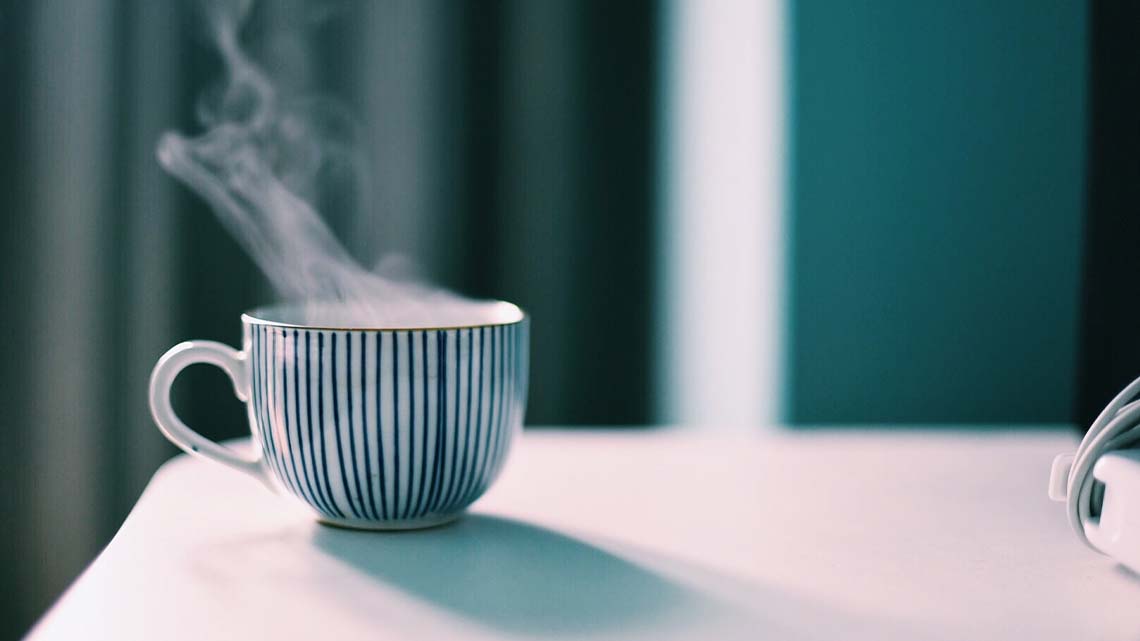 There is steam coming from the top of a hot beverage.
