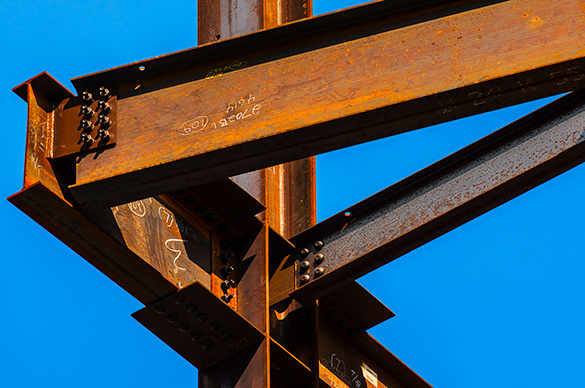 Steel beams with a joint securing them together.
