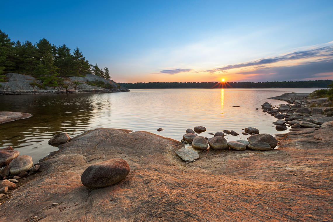 The sun setting over a body of water.