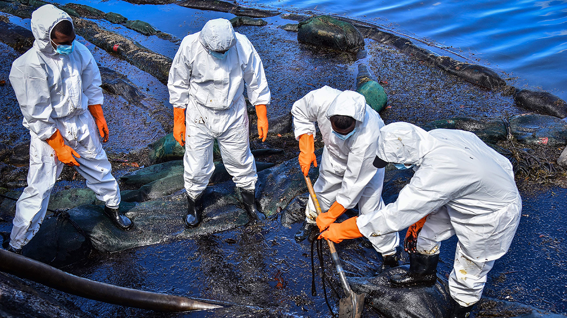 A cleanup crew cleaning up an oil spill