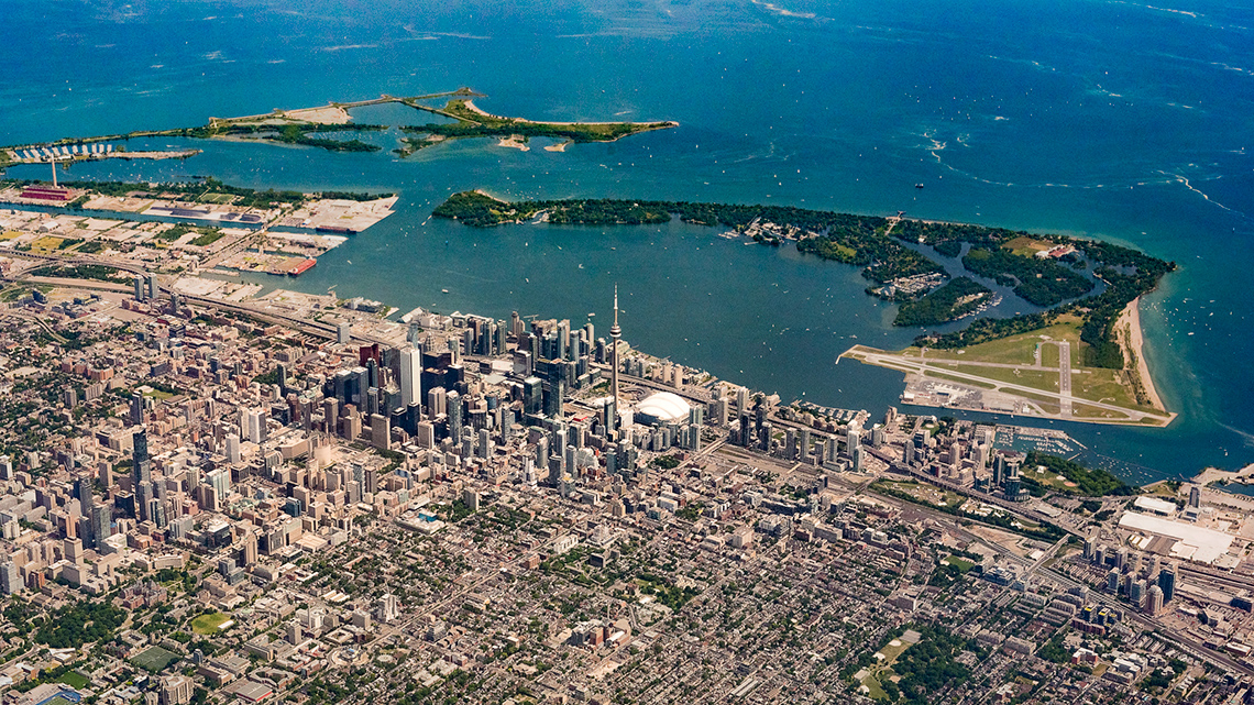 An aerial view of the city of Toronto and the lakeshore of Lake Ontario.