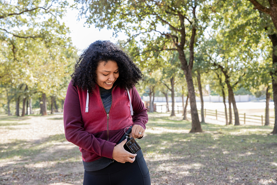 Woman checking insulin pump