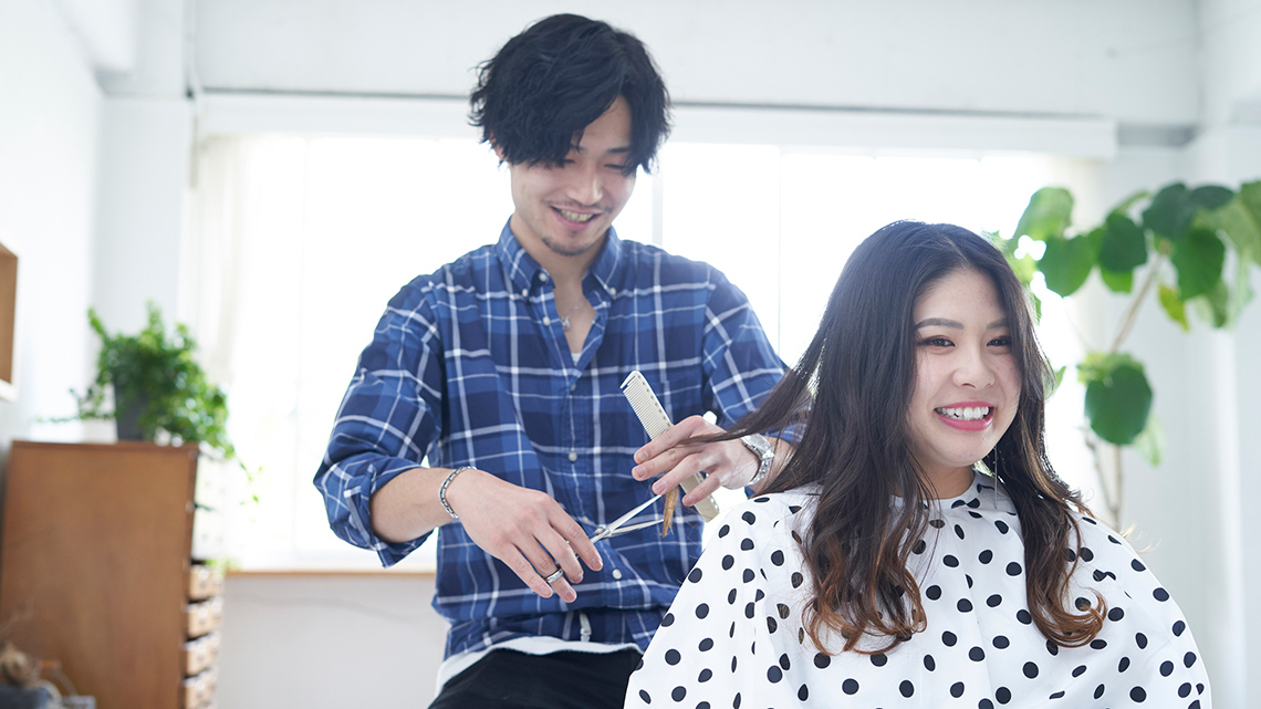 A hairdresser cutting someone's hair.