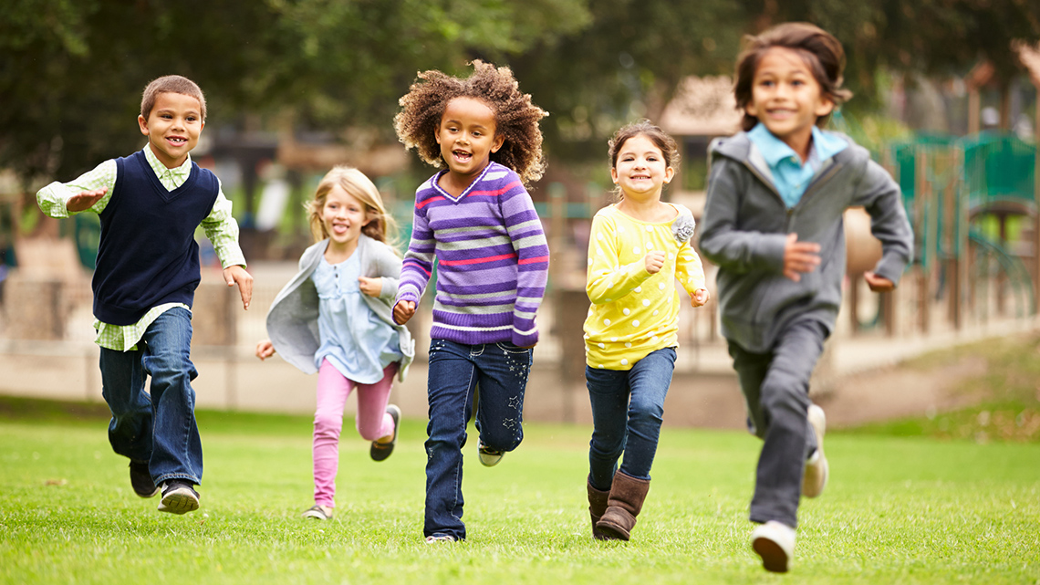 Kids running around in a playground.