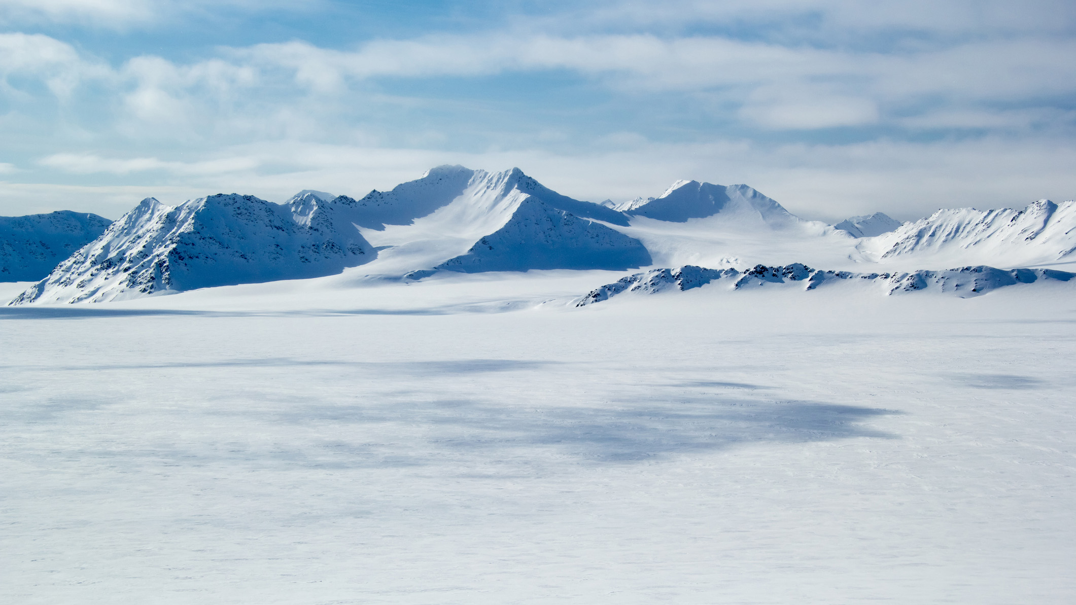 The Arctic landscape with mountains in the distance.