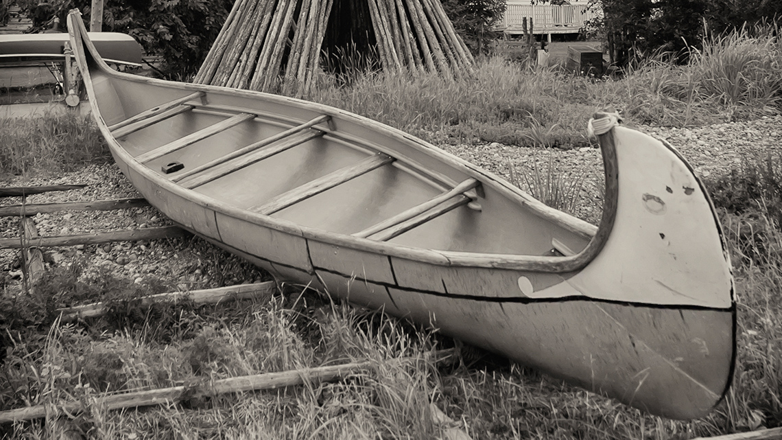 Birch bark canoe in front of a teepee nearby the Northwest River, Labrador.