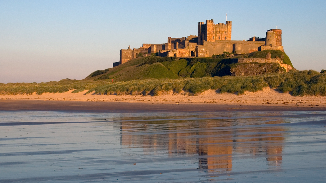 Bamburgh Castle, England Bamburgh Castle on a large hill overlooking the sea.