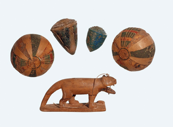 Ancient Egyptian toys from 1550 to 1070 BCE. This is a wooden cat, spinning tops, and game balls