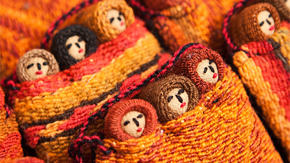 Modern Incan dolls bundled together.