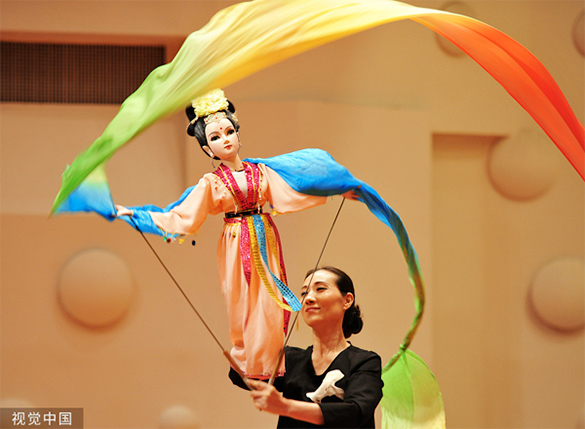 Modern day Chinese stick puppet with a stick and many colours.