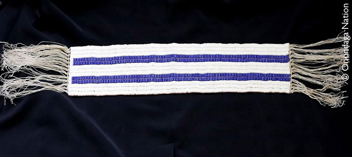 Image of the Two Row Wampum belt with two purple lines running parallel, on a white background