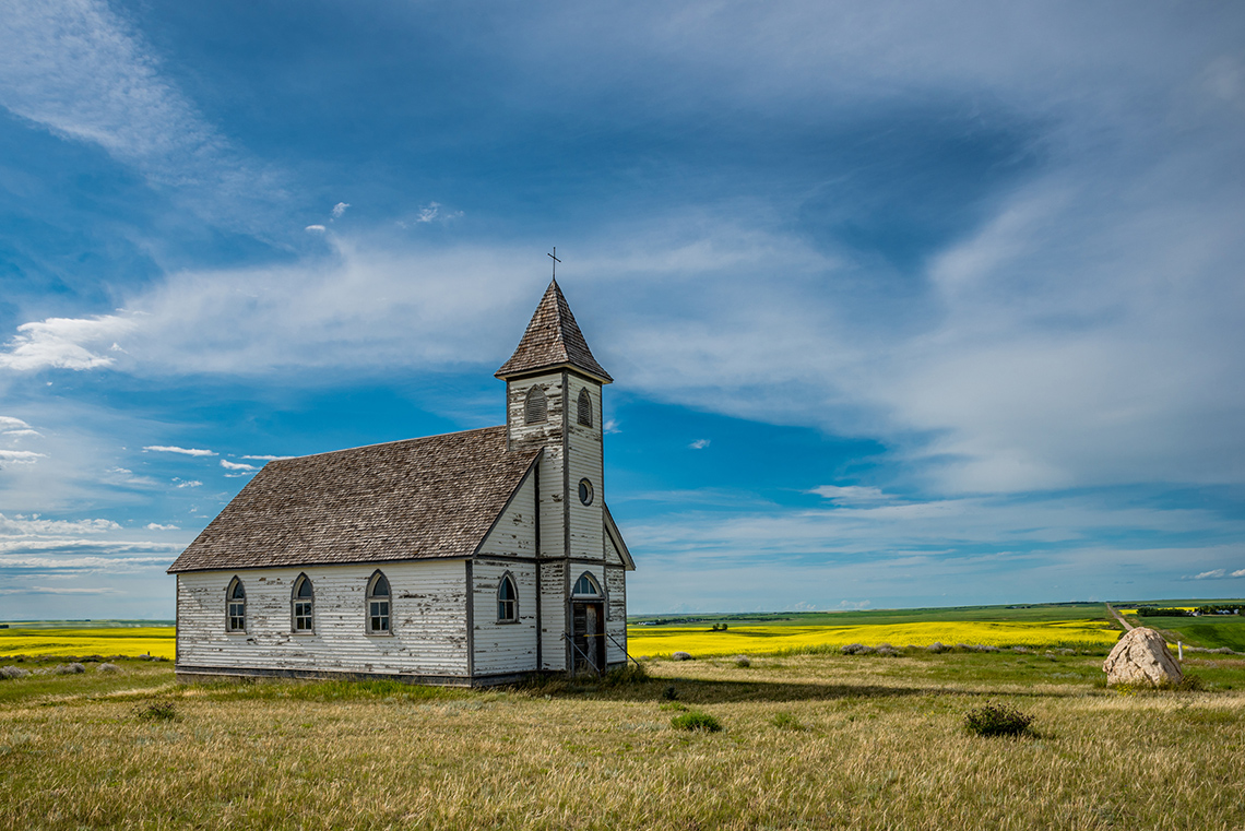 An image of a historic church in farmland.