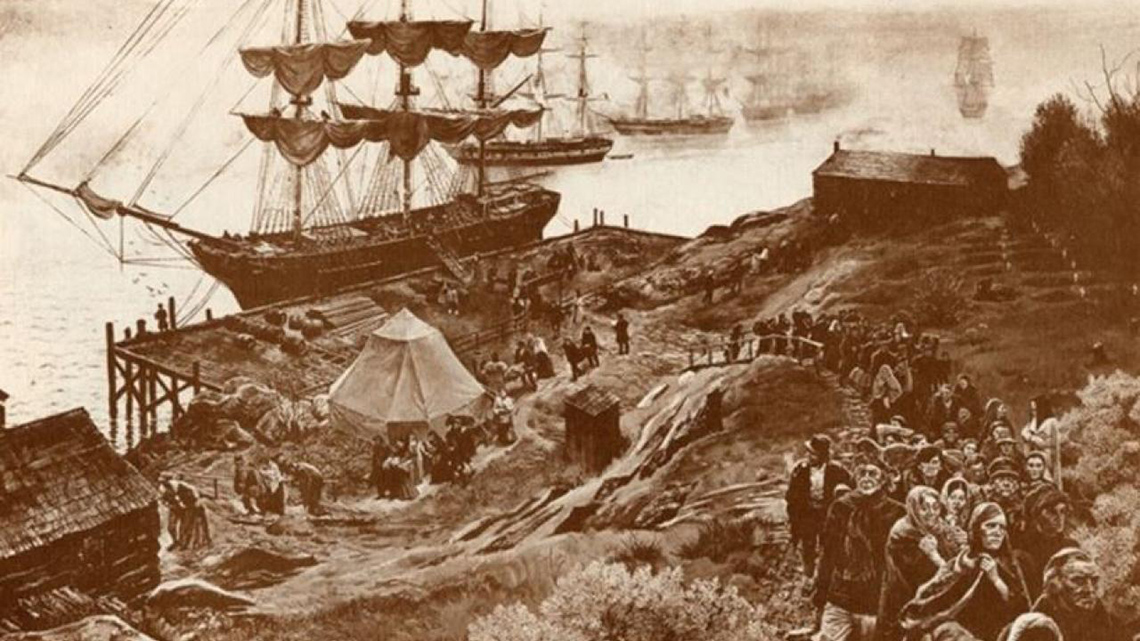 Many Irish people coming out of their ship as it lands in British North America, now called Canada.
