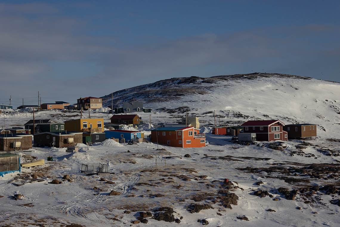 This image shows snow that covers all surfaces of the town including roads and houses.