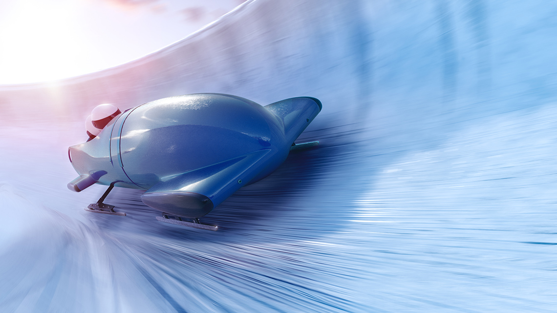 A person riding a bobsled.